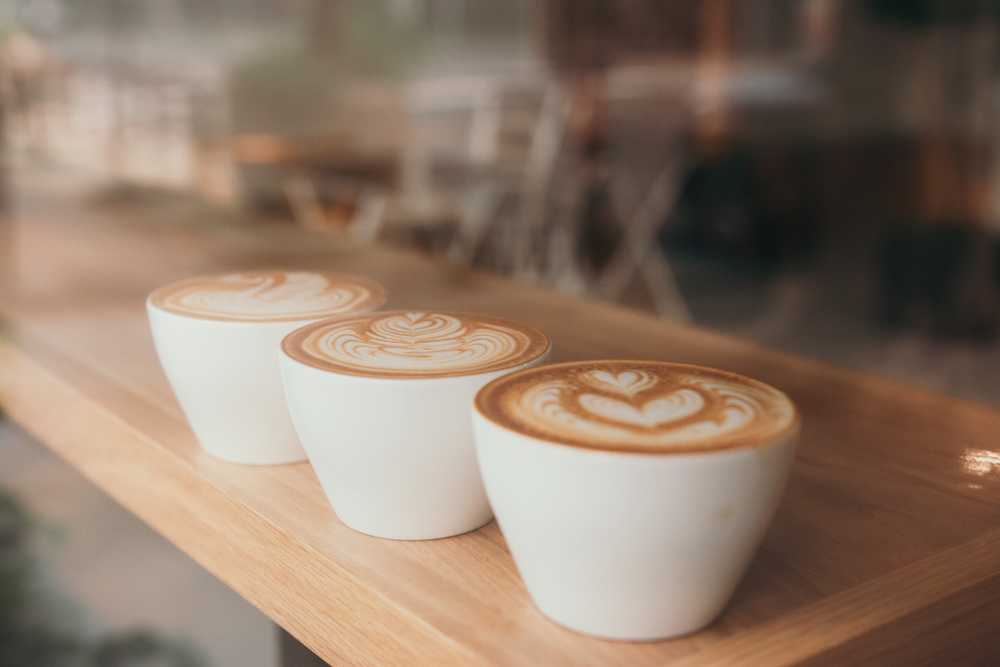 Three white ceramic cups with espresso